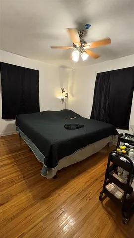 a bed room with furniture and wooden floor