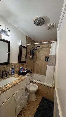 a bathroom with a double vanity sink toilet mirror and shower