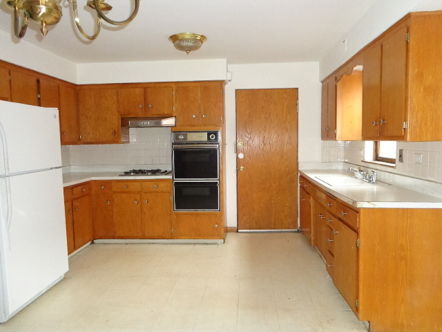 919 Elder Road Homewood, IL 60430 - Photo 3 of 12 a kitchen with stainless steel appliances granite countertop a refrigerator a sink and a stove