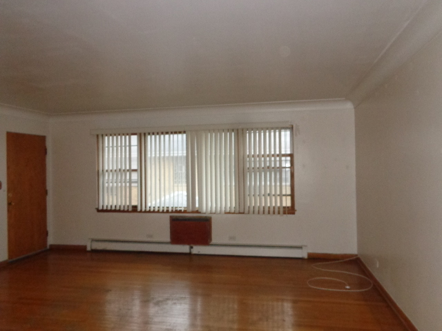 919 Elder Road Homewood, IL 60430 - Photo 8 of 12 an empty room with wooden floor and windows