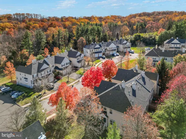an aerial view of a house with a mountain