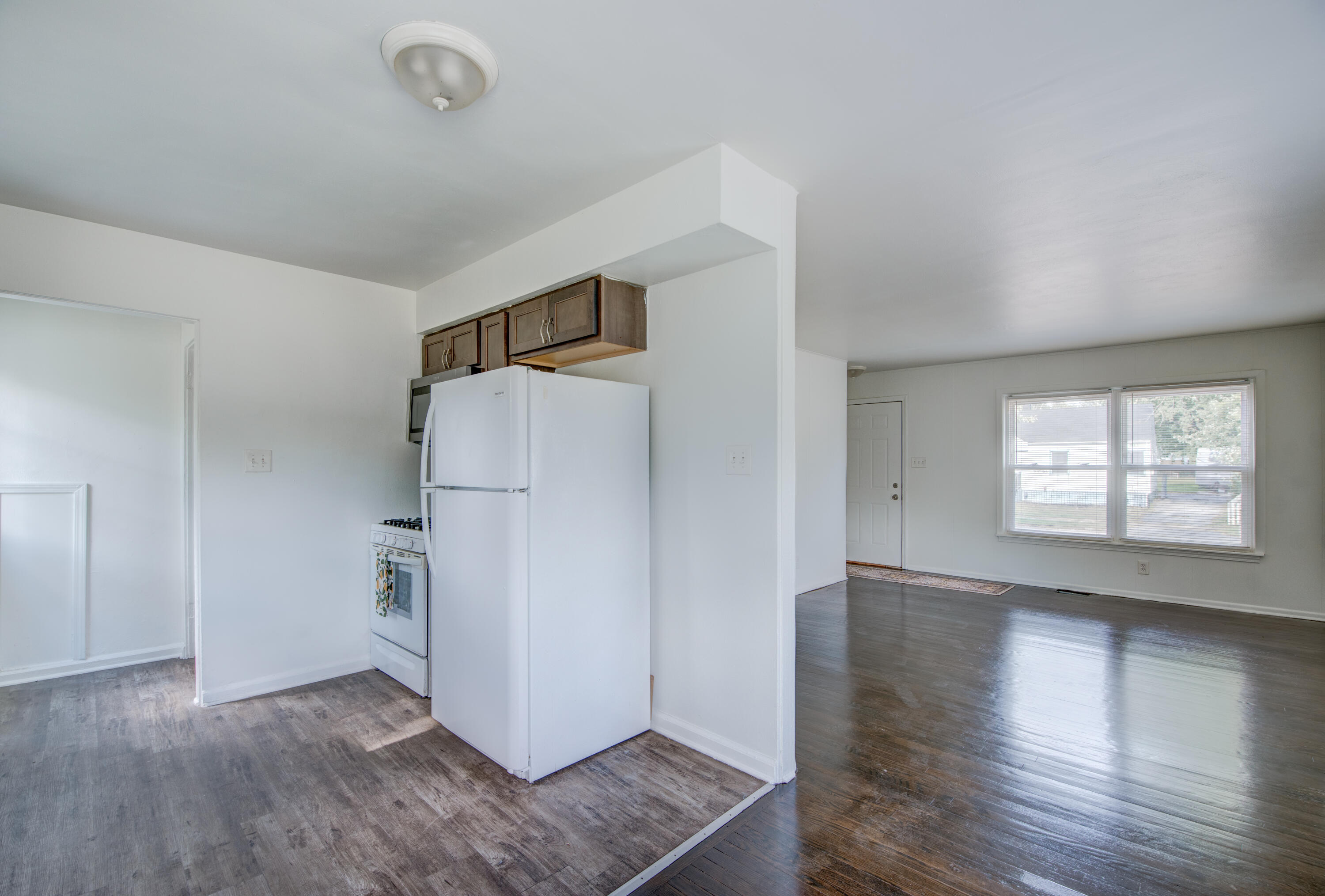 4409 East 11th Avenue Gary, IN 46403 - Photo 13 of 32 an empty room with wooden floor and windows