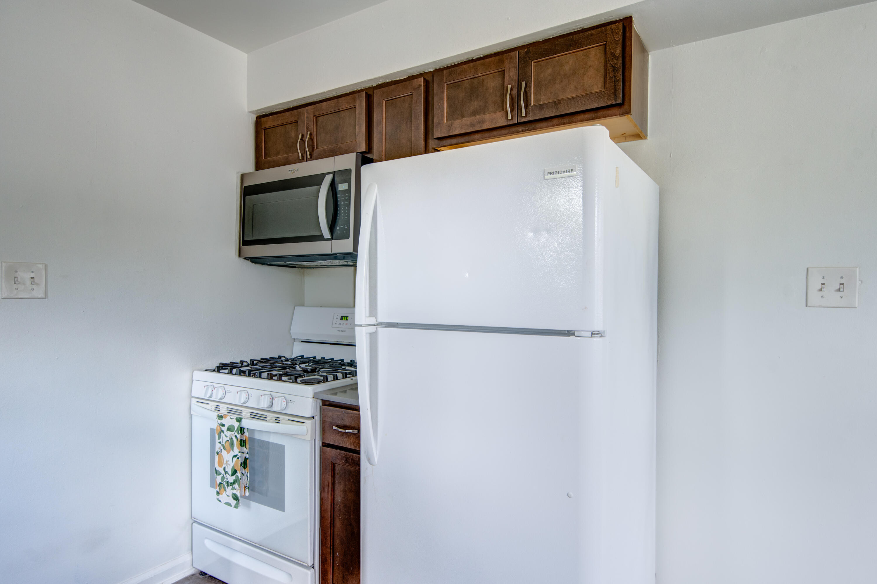 4409 East 11th Avenue Gary, IN 46403 - Photo 14 of 32 a kitchen with stainless steel appliances a refrigerator and a stove top oven