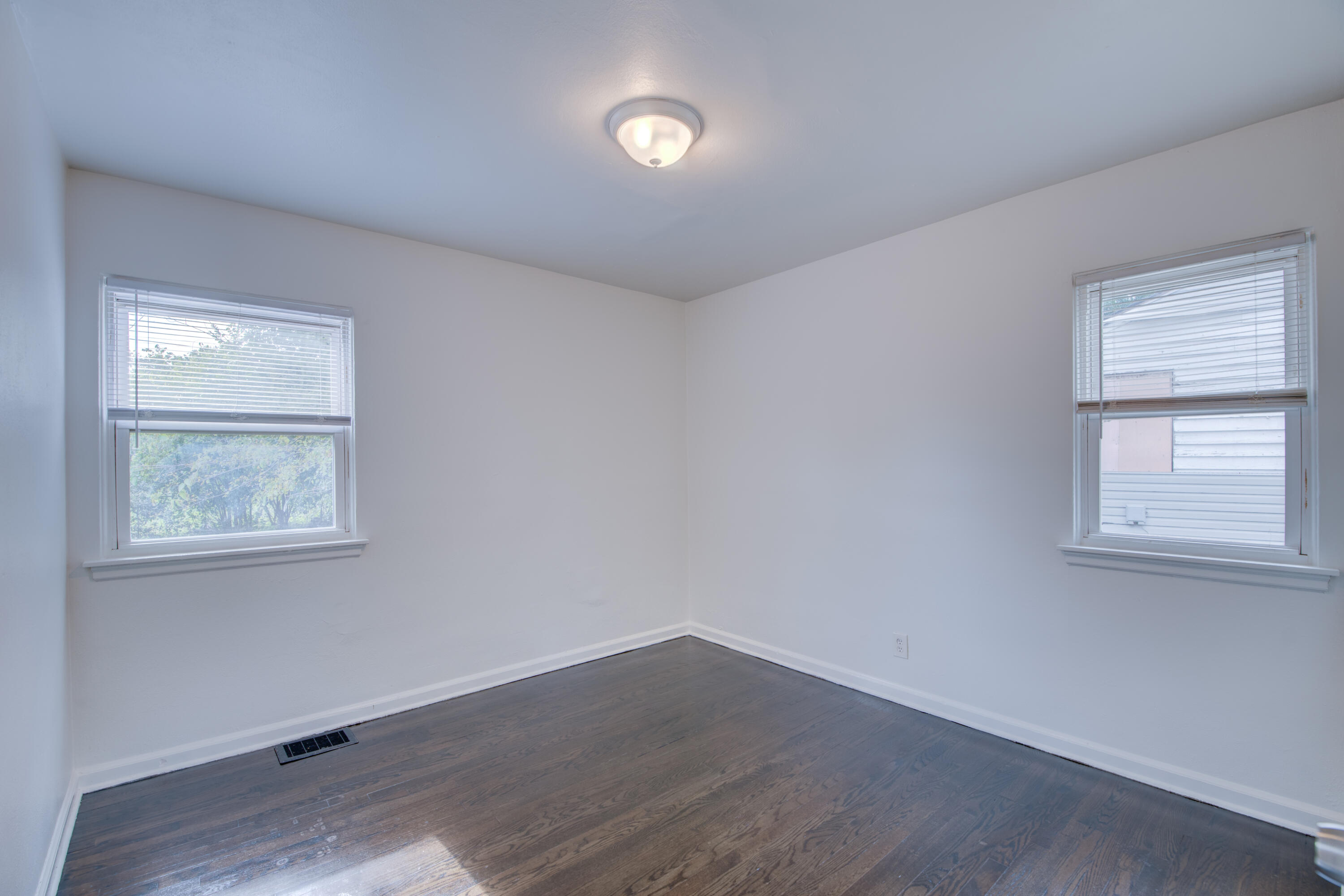 4409 East 11th Avenue Gary, IN 46403 - Photo 19 of 32 an empty room with wooden floor and windows
