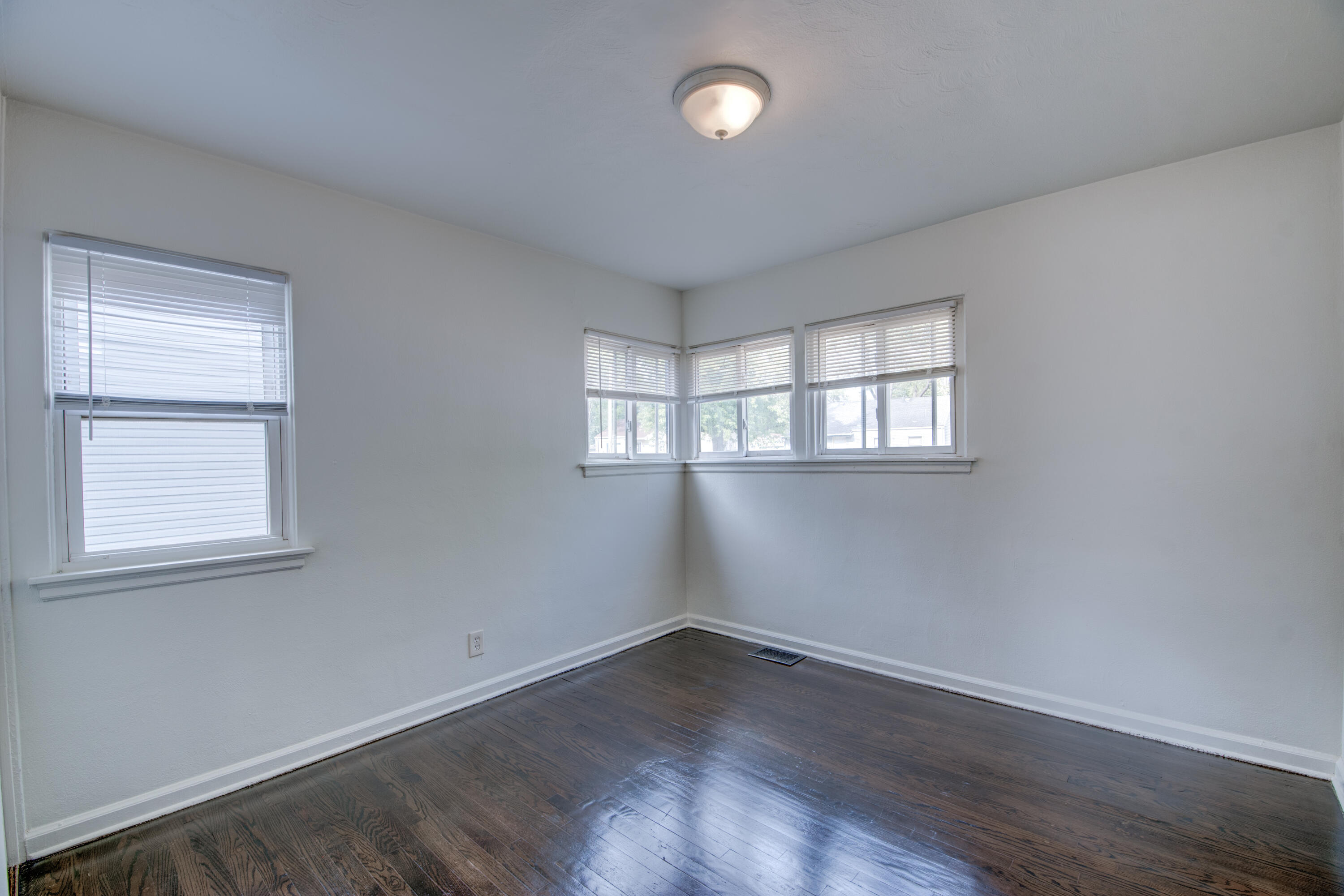4409 East 11th Avenue Gary, IN 46403 - Photo 21 of 32 an empty room with wooden floor and windows