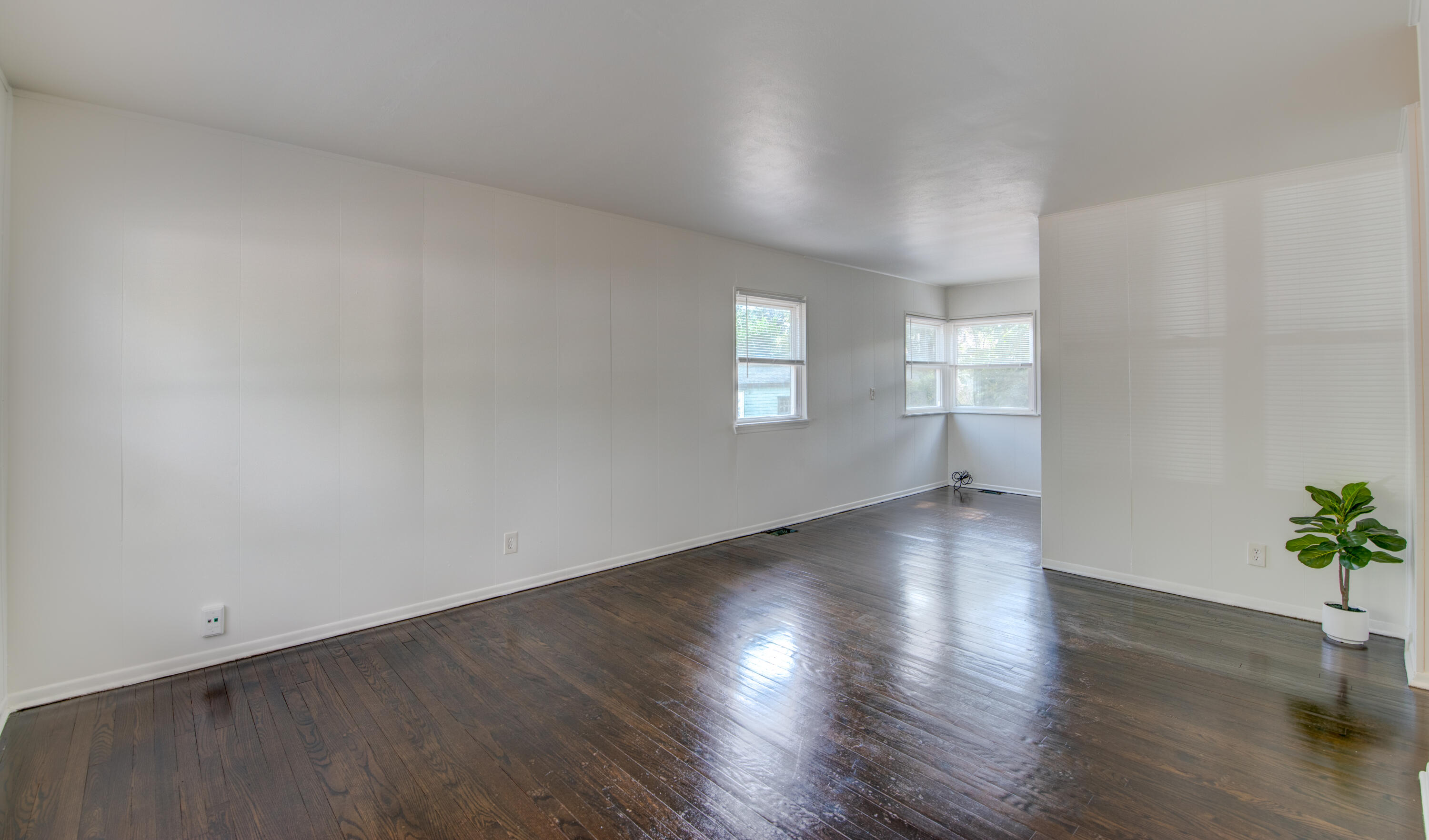 4409 East 11th Avenue Gary, IN 46403 - Photo 6 of 32 an empty room with wooden floor and windows