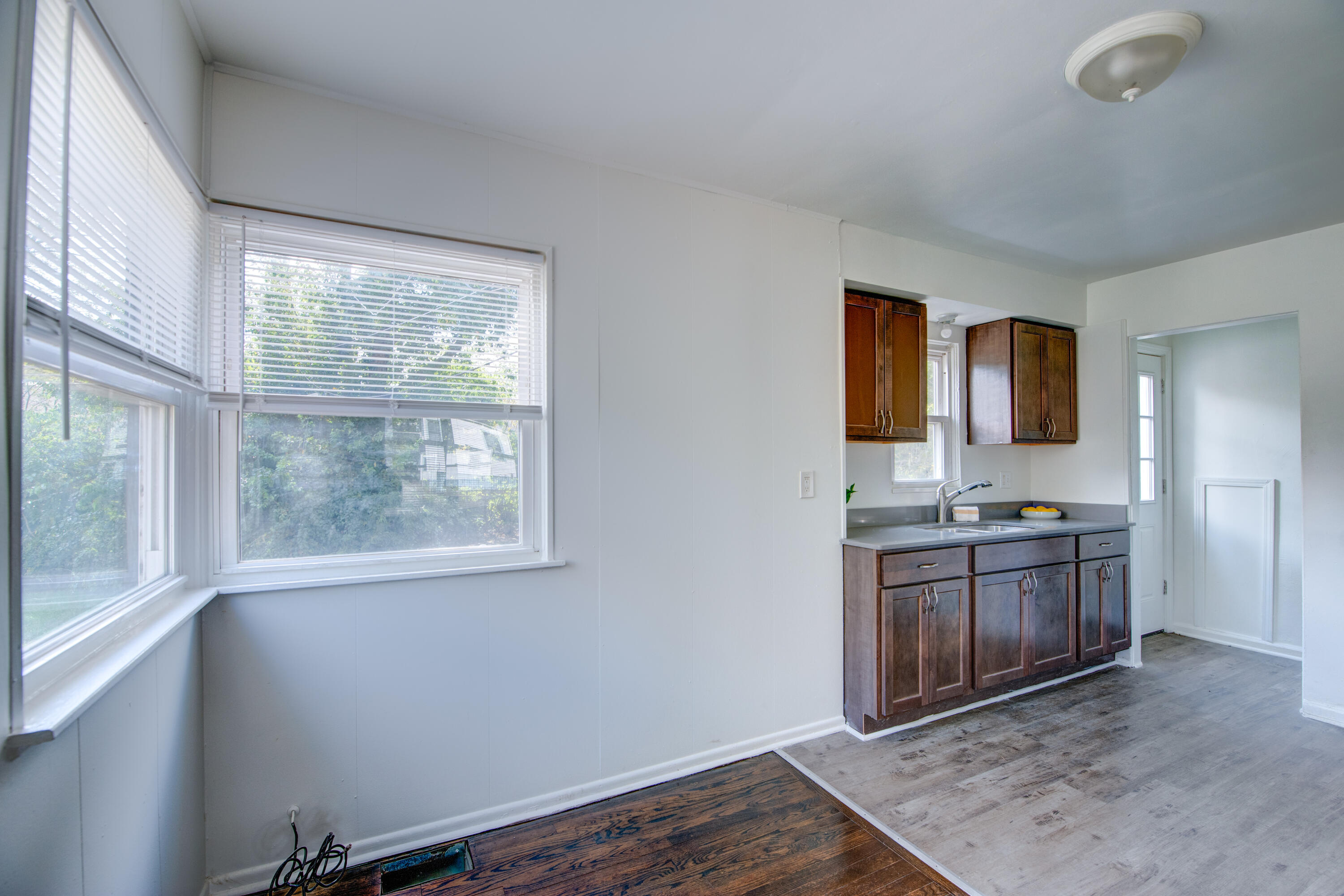 4409 East 11th Avenue Gary, IN 46403 - Photo 10 of 32 a view of an empty room with a window and wooden floor