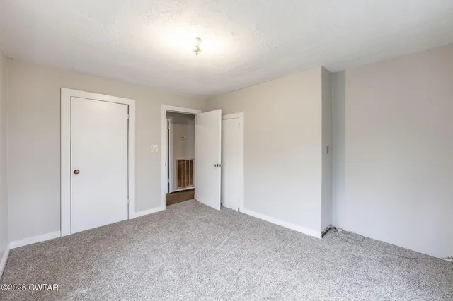 a view of an empty room and a window