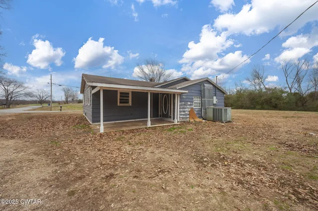 a large tree in front of a house
