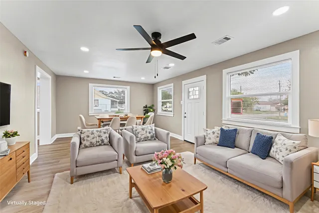 a view of a house with backyard and trees