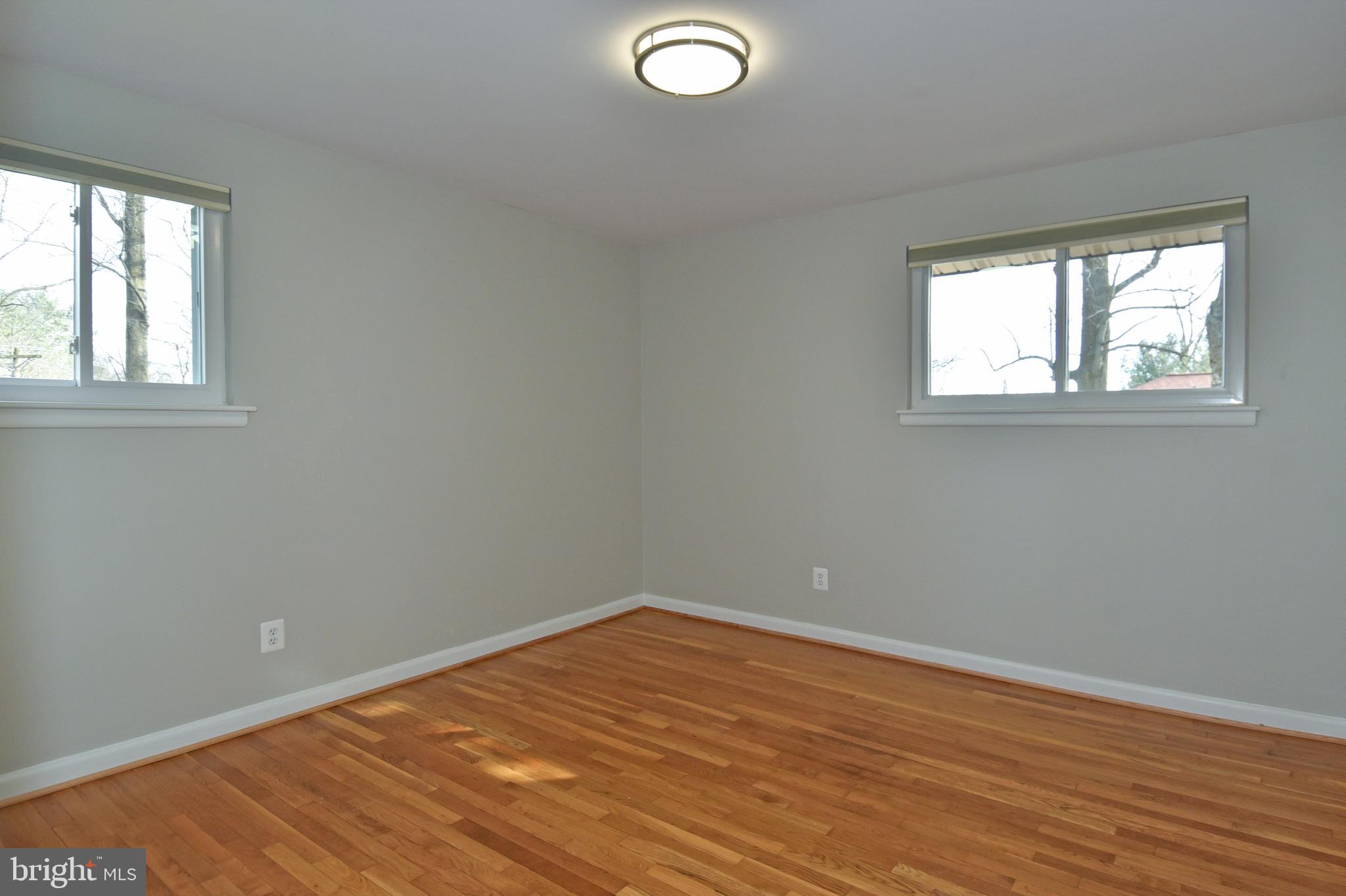 6319 Tone Court Bethesda, MD 20817 - Photo 14 of 29 an empty room with wooden floor and windows