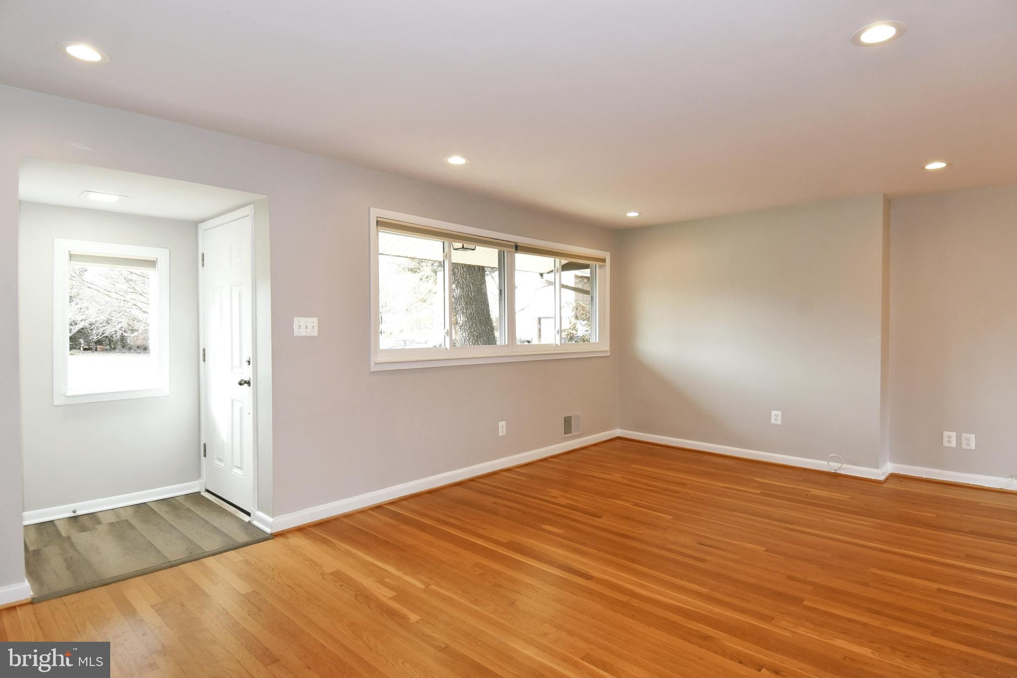 6319 Tone Court Bethesda, MD 20817 - Photo 3 of 29 a view of an empty room with wooden floor and a window