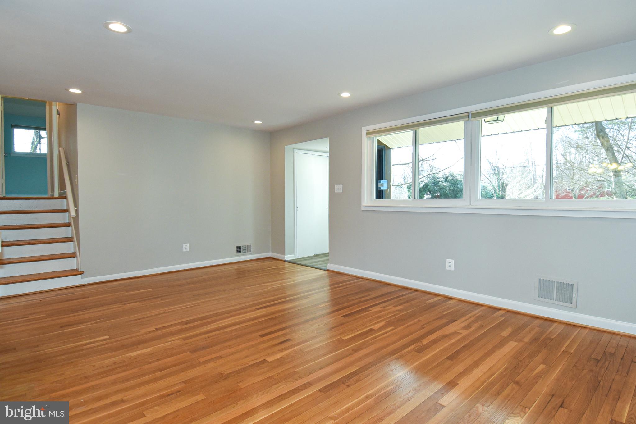 6319 Tone Court Bethesda, MD 20817 - Photo 4 of 29 an empty room with wooden floor and windows