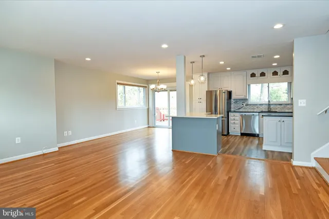 a view of kitchen view wooden floors and kitchen view
