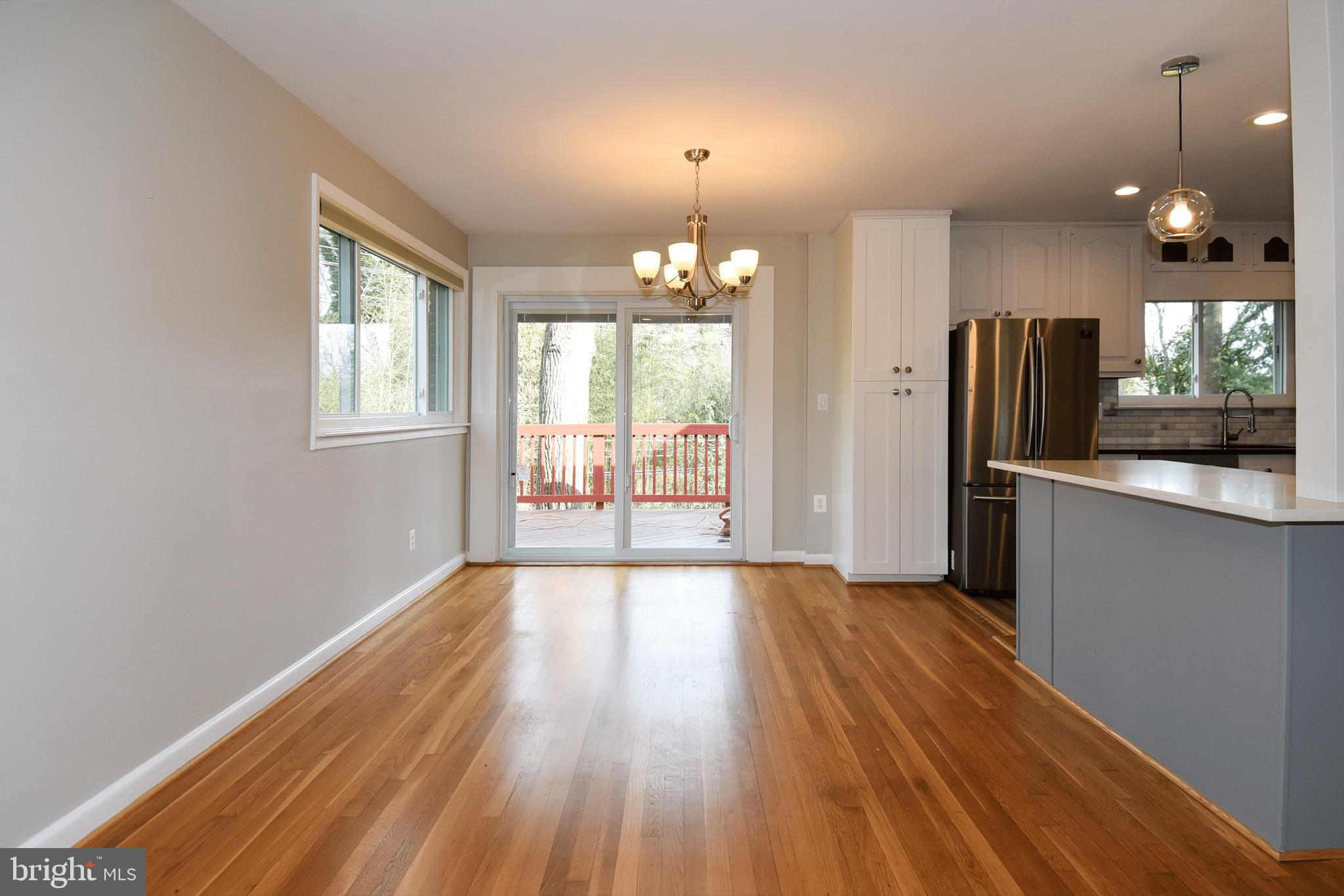 6319 Tone Court Bethesda, MD 20817 - Photo 9 of 29 an empty room with wooden floor and windows