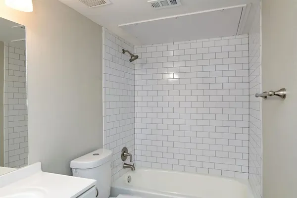 a bathroom with a bathtub and toilet