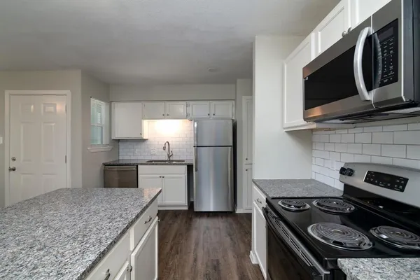 a kitchen with a stove and a microwave