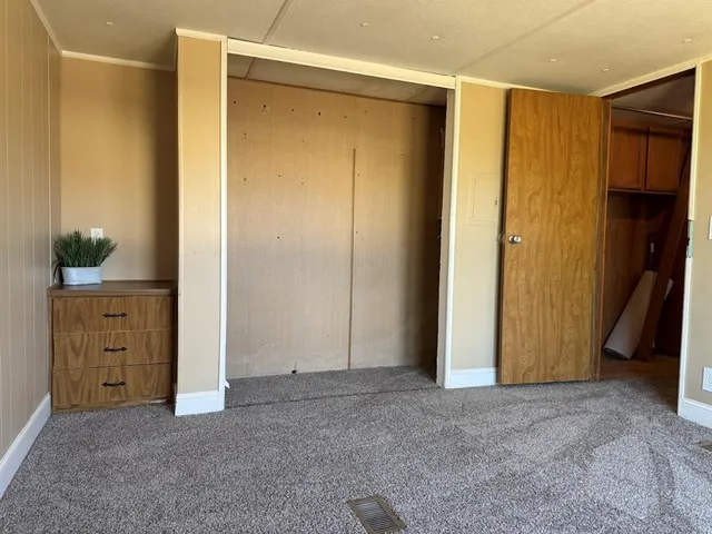 a bathroom with a toilet a window and shower