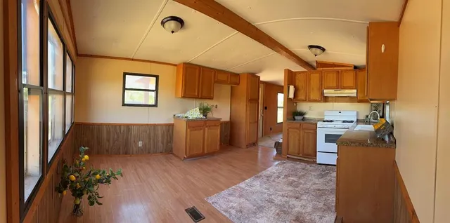 a kitchen with sink cabinets and wooden floor