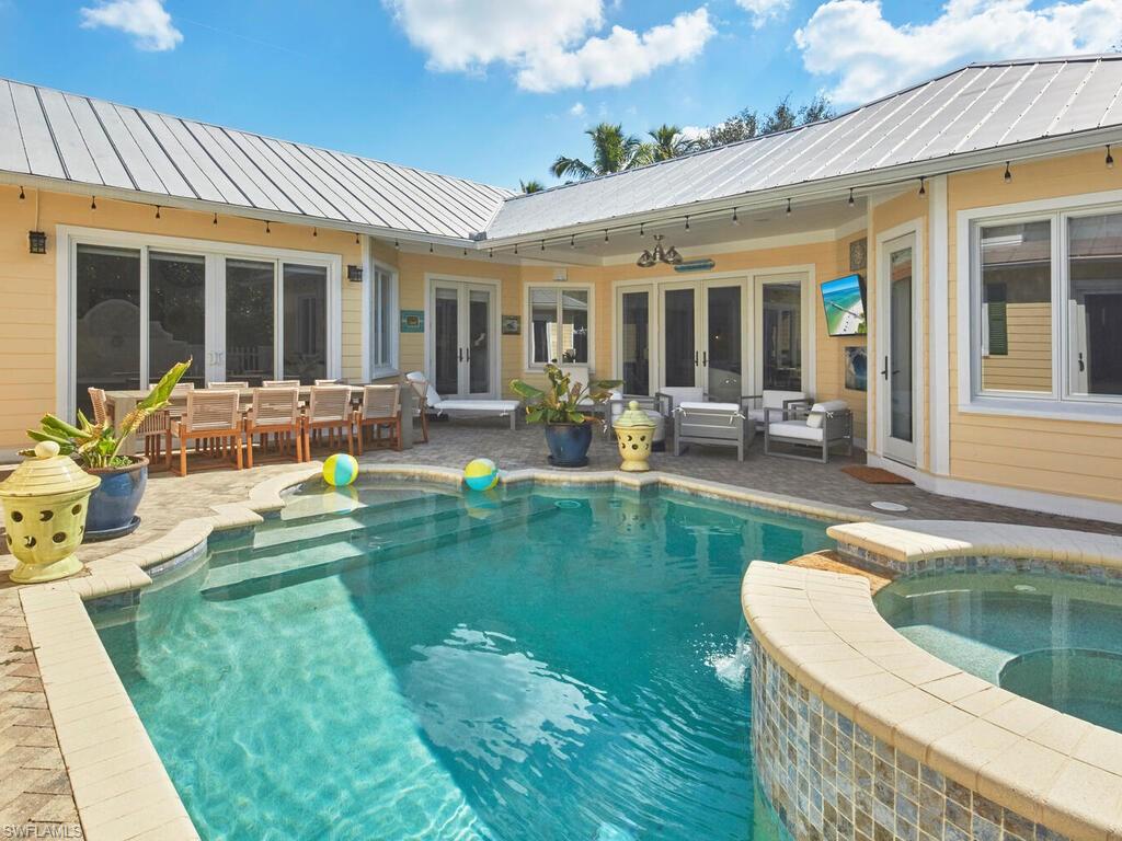 165 Broad Avenue South Naples, FL 34102 - Photo 11 of 18 a front view of house with outdoor seating yard