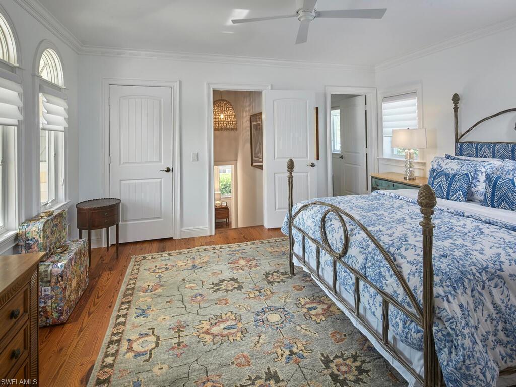 165 Broad Avenue South Naples, FL 34102 - Photo 13 of 18 a bedroom with a bed and a table in it