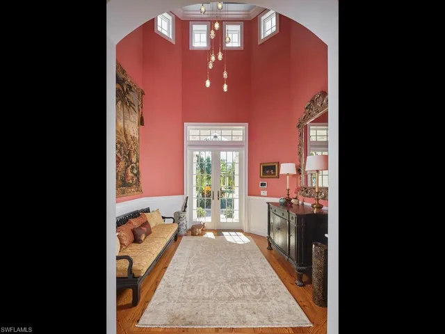a view of a hallway with a dining table & chairs