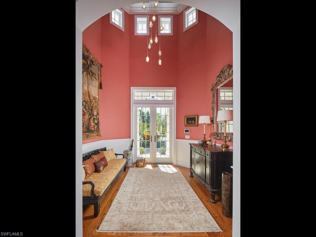 165 Broad Avenue South Naples, FL 34102 - Photo 3 of 18 a view of a hallway with a dining table & chairs