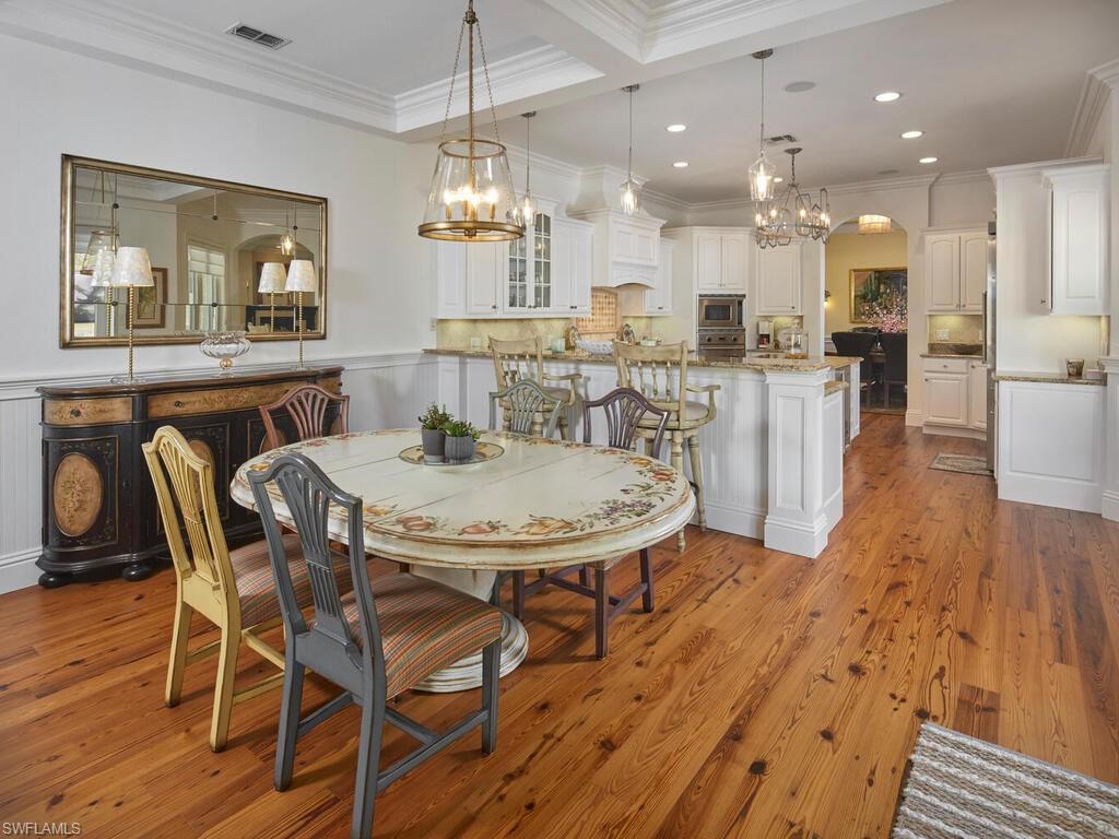 165 Broad Avenue South Naples, FL 34102 - Photo 5 of 18 a view of a dining room with furniture and wooden floor