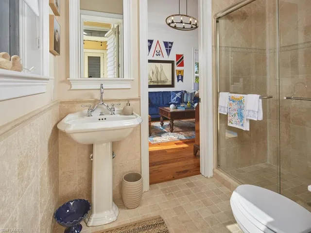 a bathroom with a sink toilet and shower