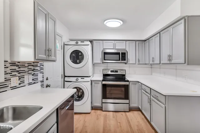a kitchen with kitchen island a sink appliances and cabinets