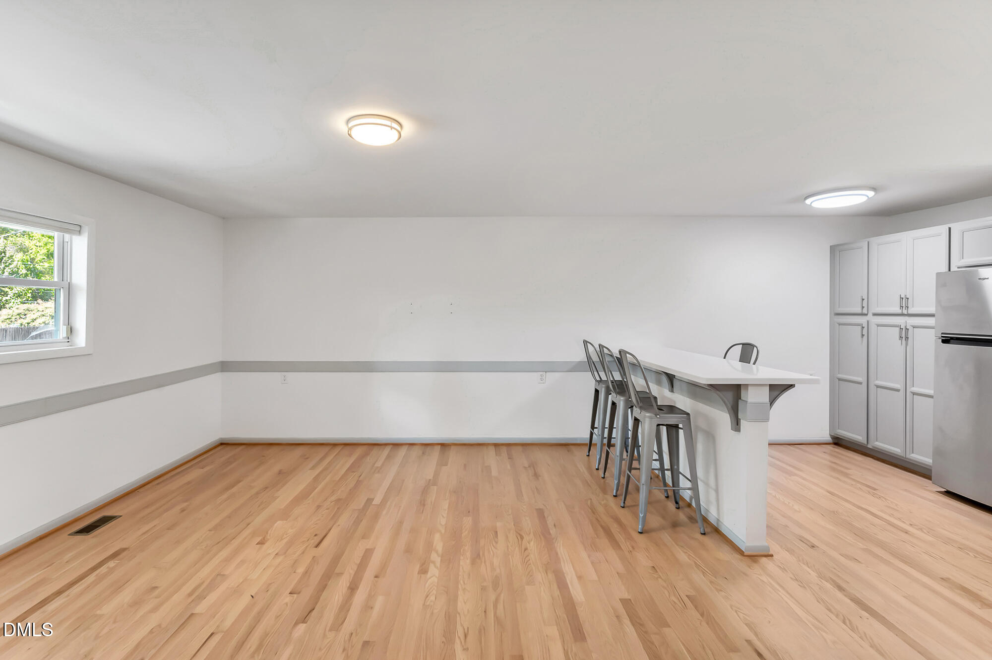 103 Hargraves Street, Unit K Carrboro, NC 27510 - Photo 8 of 19 a view of a room with wooden floor white walls and windows