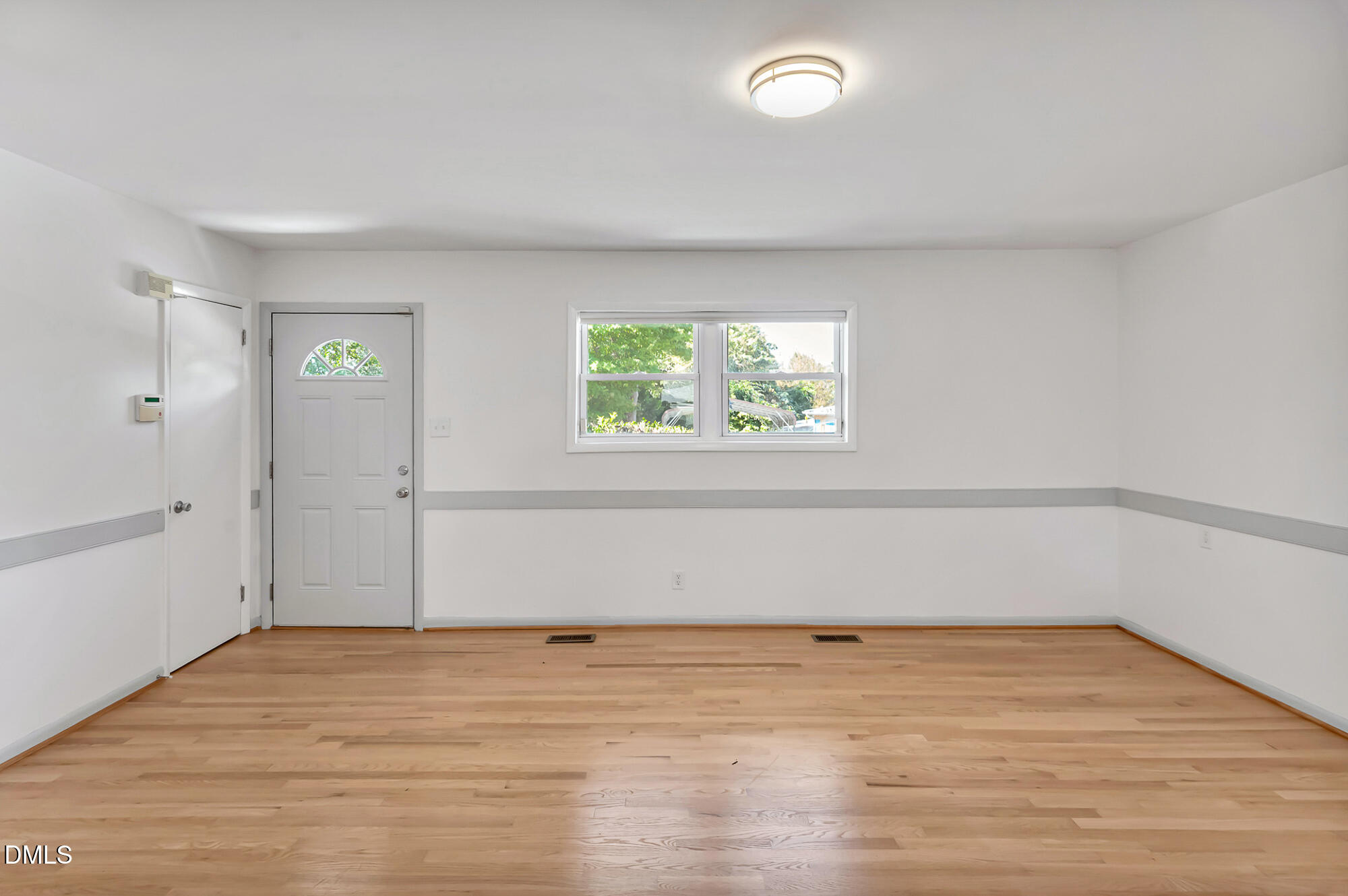 103 Hargraves Street, Unit K Carrboro, NC 27510 - Photo 9 of 19 a view of empty room with wooden floor and fan