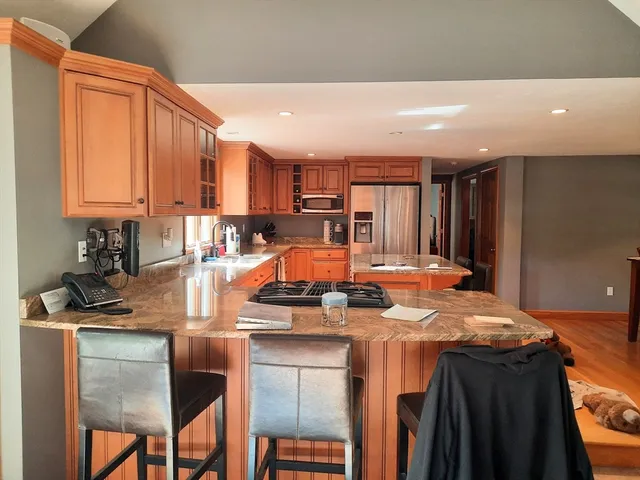 a kitchen with a table chairs and a refrigerator
