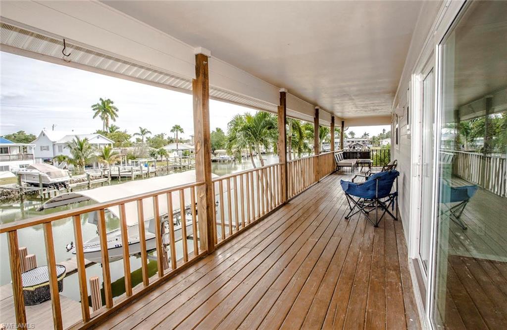 604 Sunset Court Goodland, FL 34140 - Photo 11 of 14 a view of a room with wooden floor and furniture