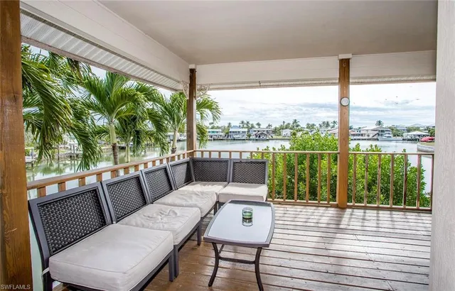a view of a city from a balcony with furniture