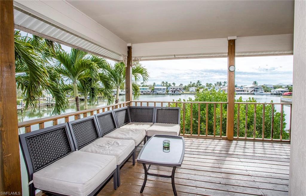 604 Sunset Court Goodland, FL 34140 - Photo 13 of 14 a view of a city from a balcony with furniture