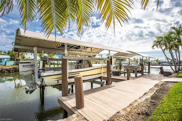 a view of a patio with a table and chairs under an umbrella