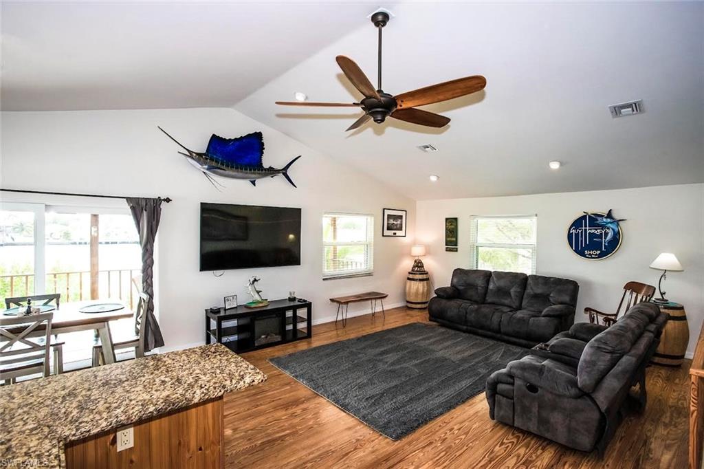 604 Sunset Court Goodland, FL 34140 - Photo 4 of 14 a living room with furniture and a flat screen tv