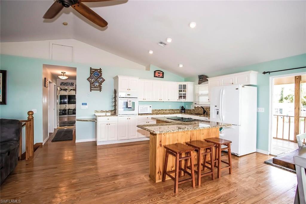 604 Sunset Court Goodland, FL 34140 - Photo 5 of 14 a kitchen with stainless steel appliances a stove a sink dishwasher and a refrigerator