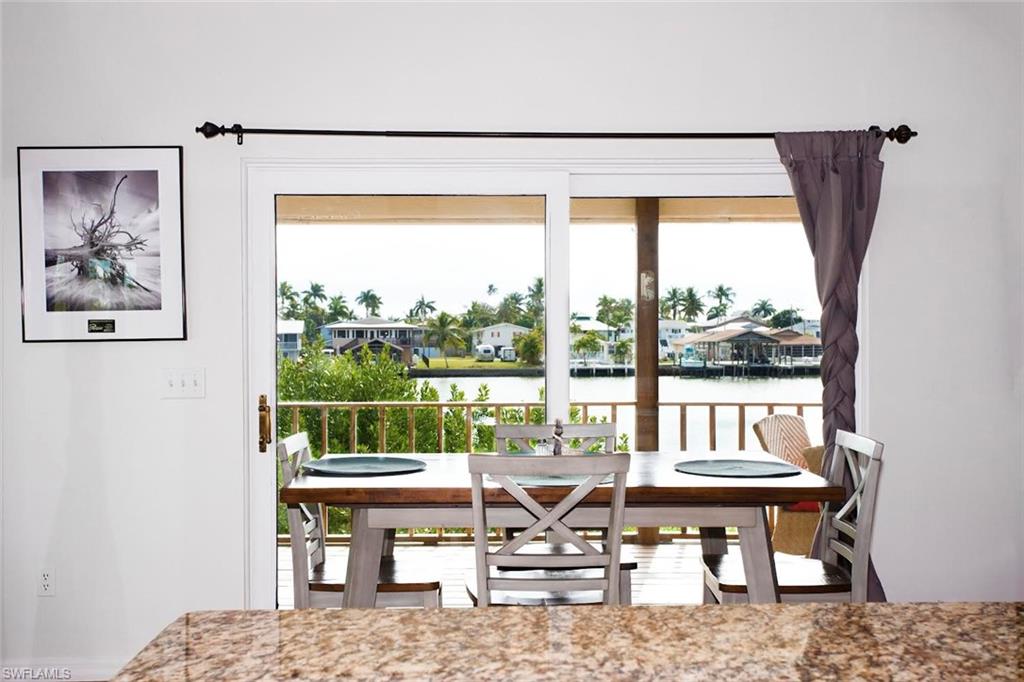 604 Sunset Court Goodland, FL 34140 - Photo 6 of 14 a living room with a table and a large window
