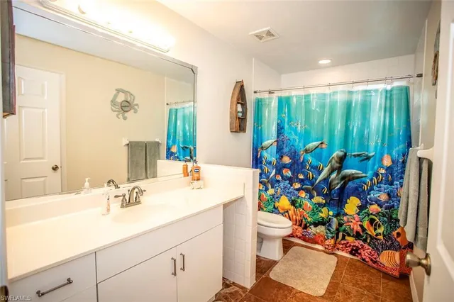 a bathroom with a sink mirror and vanity