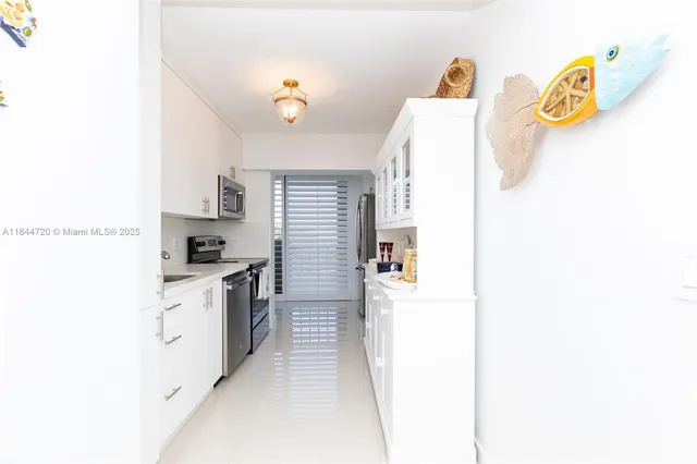 a kitchen with stainless steel appliances a sink stove and cabinets