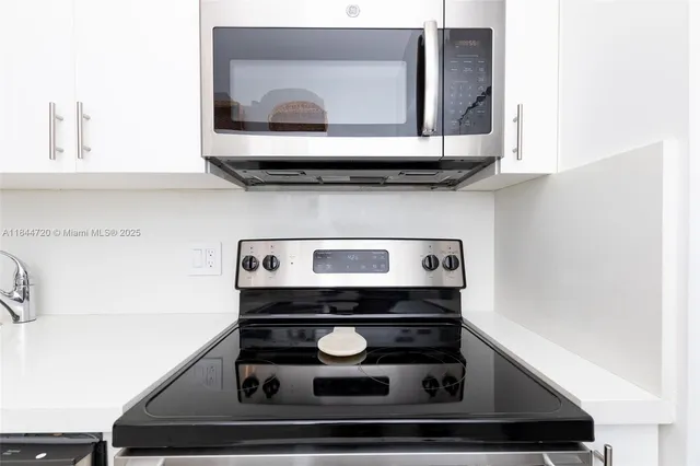 a kitchen with stainless steel appliances granite countertop a sink and a stove