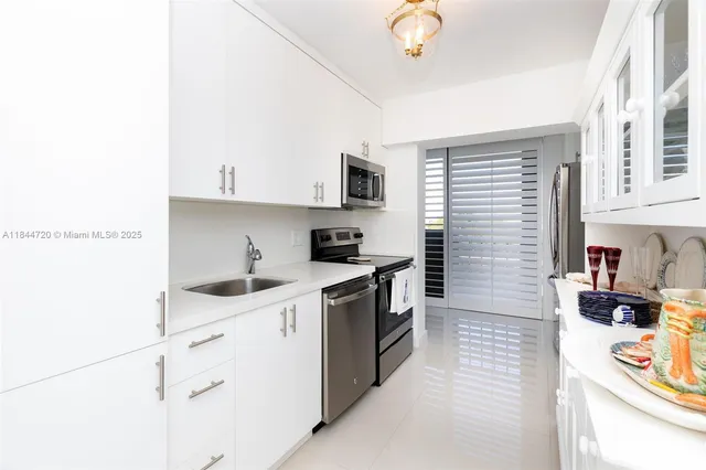a view of a kitchen with living room and windows