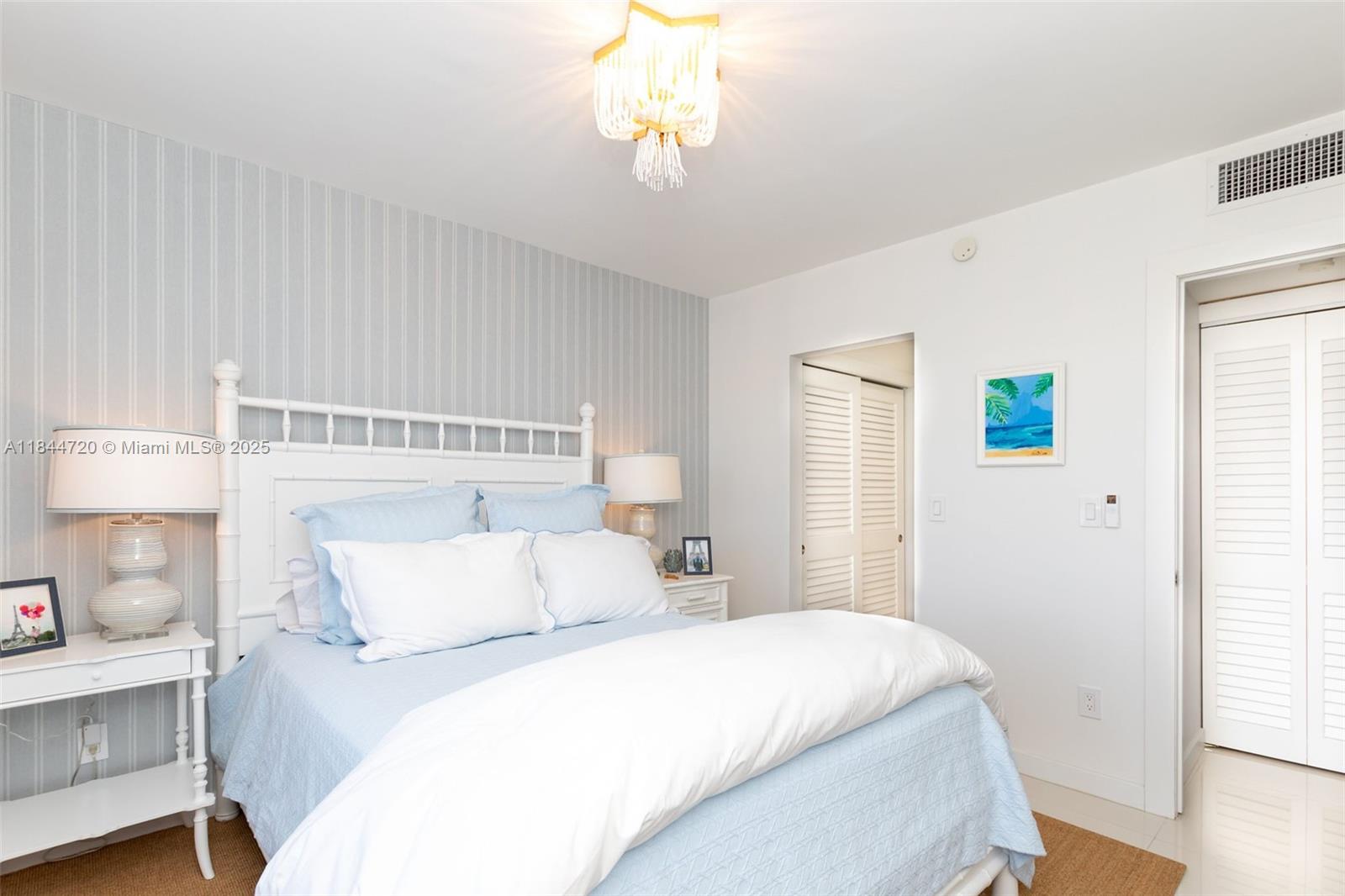 77 Crandon Boulevard, Unit 5B Key Biscayne, FL 33149 - Photo 28 of 41 a bedroom with a bed and a window