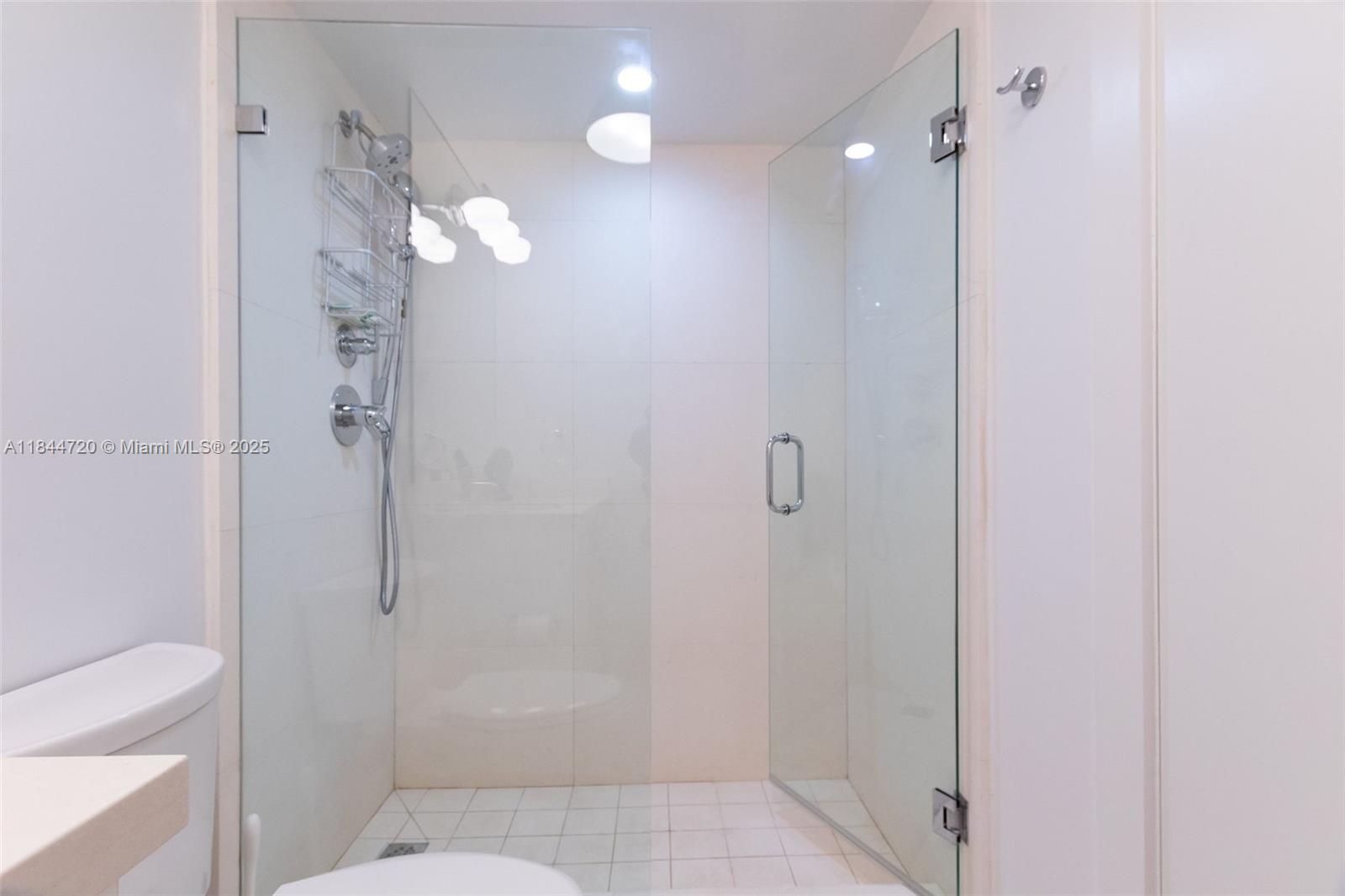 77 Crandon Boulevard, Unit 5B Key Biscayne, FL 33149 - Photo 32 of 41 a bathroom with a shower a toilet and a sink