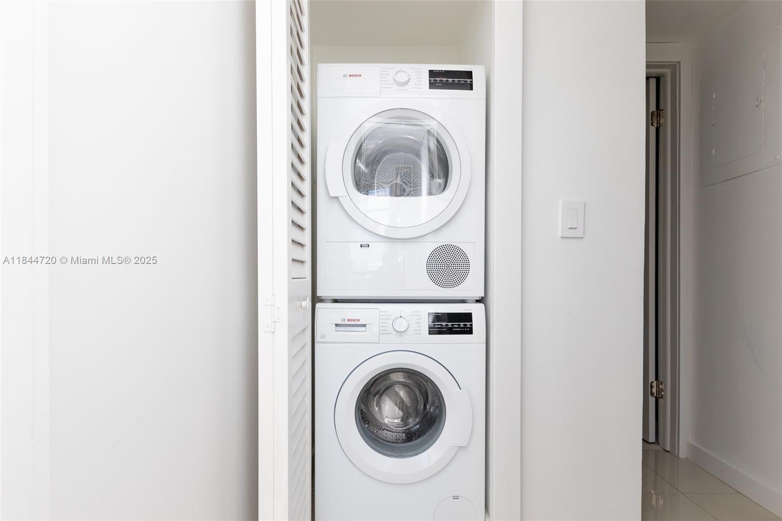 77 Crandon Boulevard, Unit 5B Key Biscayne, FL 33149 - Photo 35 of 41 a utility room with dryer and washer