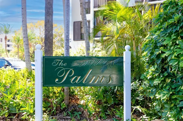 a sign broad in front of flowers
