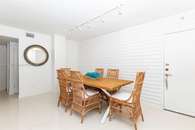 a view of a dining room with furniture and a chandelier