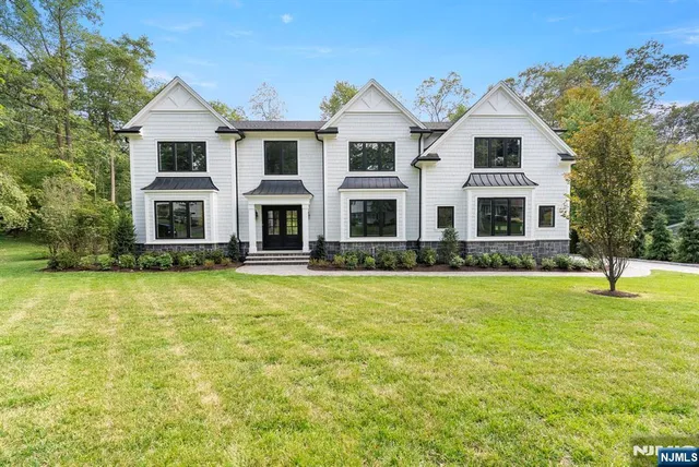 a large kitchen with a lot of counter space and stainless steel appliances